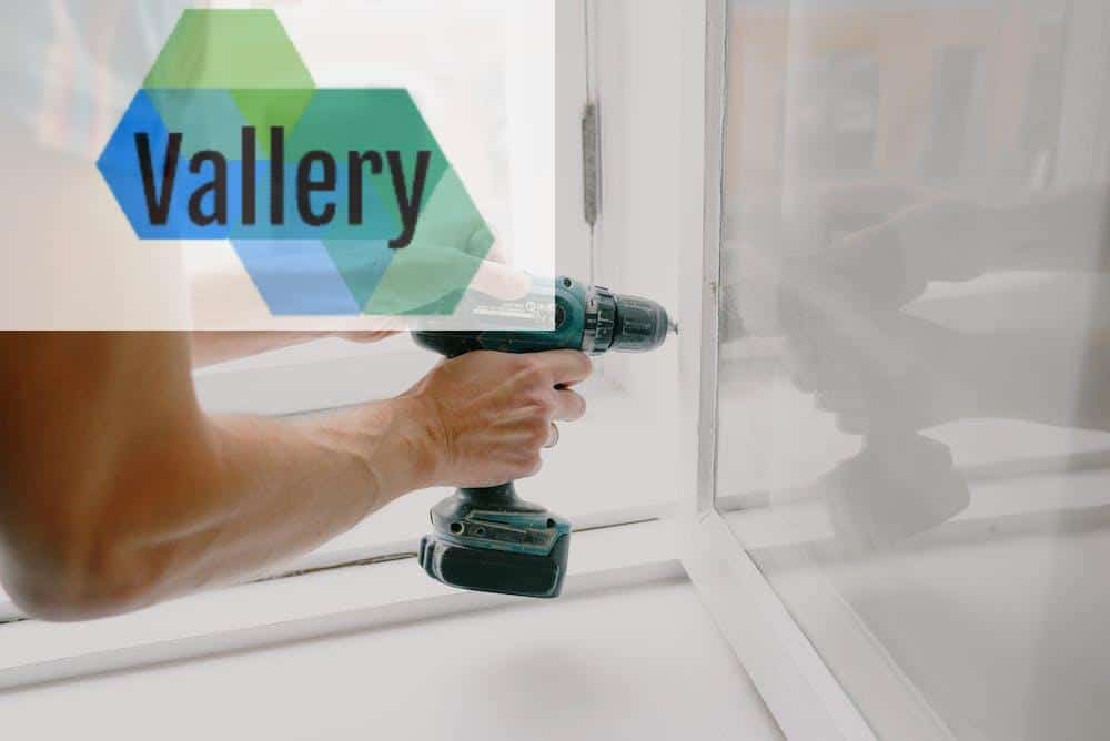 Workman screwing window frame during housework
