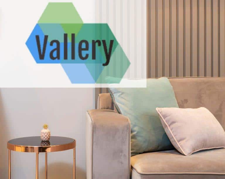 Soft cozy sofa with cushions placed near round coffee table in light contemporary living room