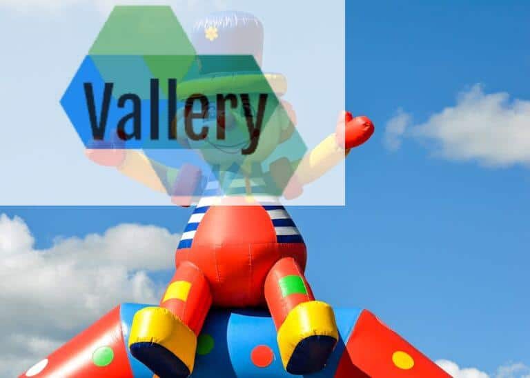 A vibrant inflatable clown at an outdoor carnival under a bright blue sky, symbolizing fun and joy.