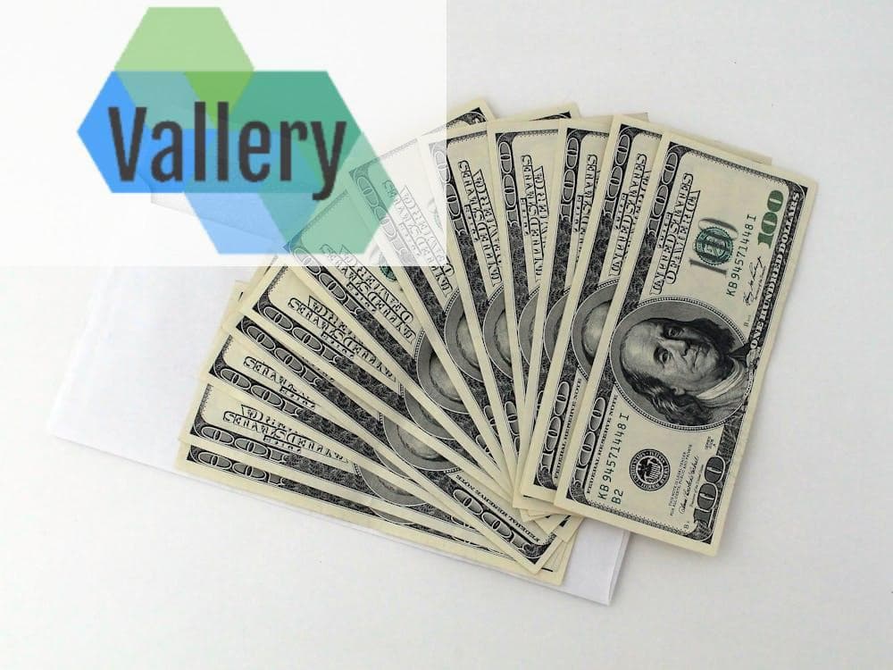 Fan of US $100 bills partially out of a white envelope on a white background.