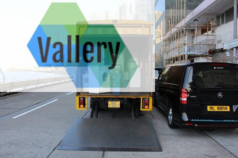 white front-load washer in yellow delivery truck